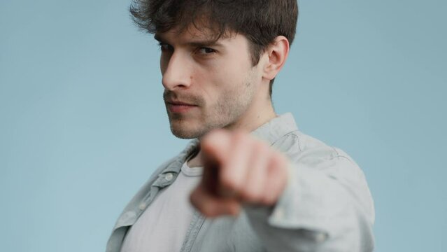 I choose you, baby. Close up portrait of confident young guy looking at camera, pointing with finger and nodding head