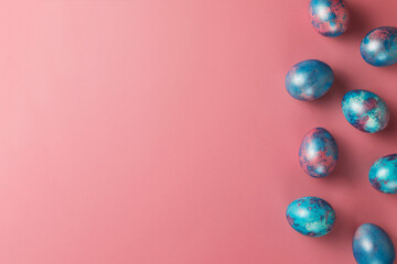 Easter eggs. Dyed Easter eggs with marble stone effect pink and blue color  on pink background. Top view. Happy Easter concept.