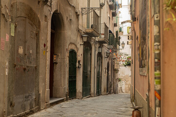 Ancient streets of the southern sea city. Lovely houses with shutters. Tourism in old Europe - Salerno, Southern Italy.