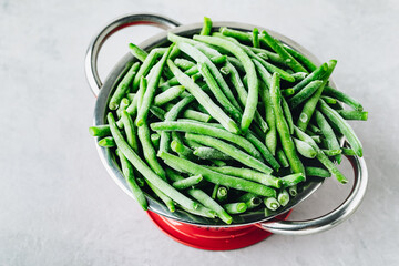 Frozen green beans in a colander ready for cooking