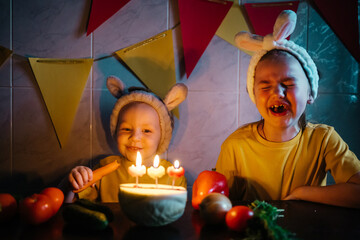 vegetarian cake with candles birthday vegetables kids in bunny ears girl crying