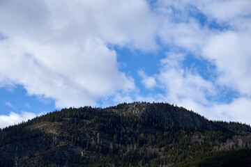 Fototapeta premium clouds over the mountains in Gudbrandsdalen Valley, Oppland, Norway, south of Harpefoss