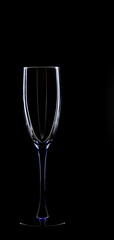 A glass of young wine on a black background.