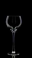 A glass of young wine on a black background.