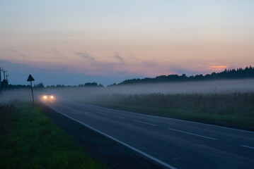 Car on the road in the fog