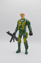 standing lonely figure of a soldier in a combat suit military uniform with a machine gun in his hands