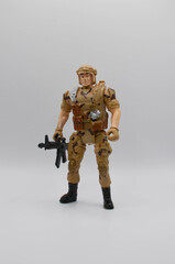 standing lonely figure of a soldier in a combat suit military uniform with a machine gun in his hands