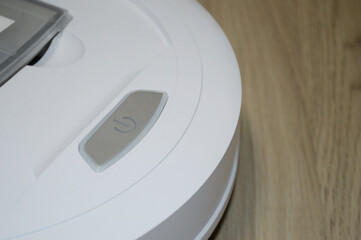 robot vacuum cleaner on laminate floor. Smart House. Home assistant concept
