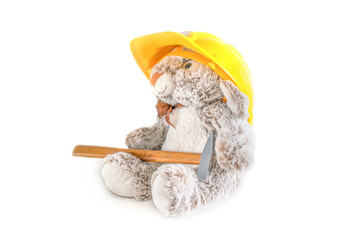 Furry, cuddly, cute little rabbit bunny toy in yellow helmet with hammer on white background, mockup with copy space, toys for children, boys, girls, kids development, playing, childhood fun