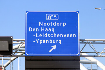 Blue direction and information sign for the directions on Motorway A12 junction 5 to Nootdorp