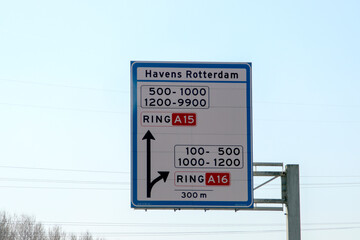 Blue direction and information sign for the directions on Motorway A16 to the Harbours