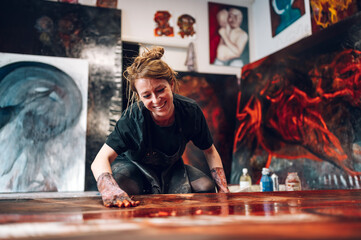 Female painter artist painting and creating her art in a creative studio - obrazy, fototapety, plakaty