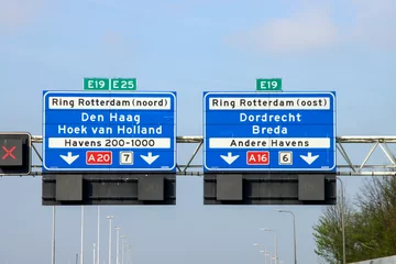 Deurstickers Blue Direction sign for the directions on Motorway A20 for directions A16 Dordrecht and A20 Hoek van Holland and The Hague. © André Muller