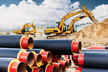 insulated pipe. Large metal pipes with a plastic sheath at a construction site against the...