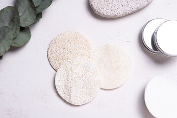 Set of luffa pads on wooden table