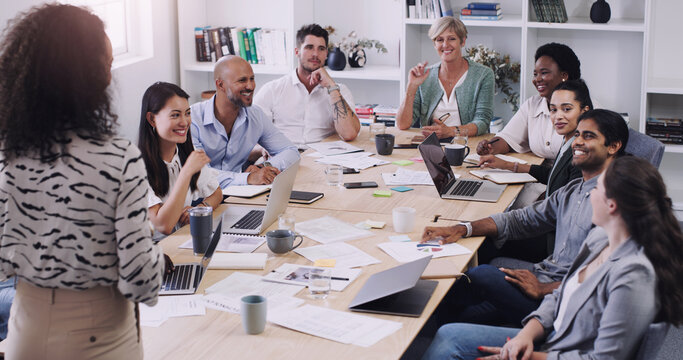 Keeping Everyone Informed Keeps Everyone On Track. Shot Of A Group Of Businesspeople Having A Meeting In A Modern Office.