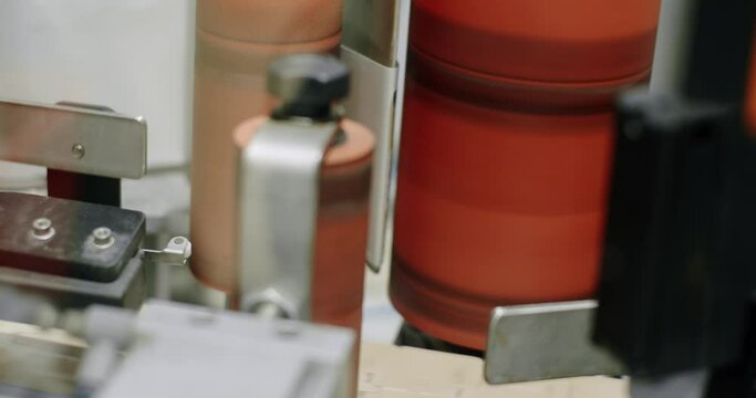 Capping process of full beer bottles. Machine for capping bottles. Factory. Beer bottles on automated machine during capping process. bottles moving on a conveyor belt.