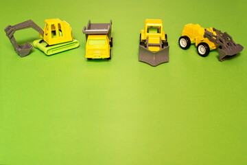 toy cars, construction equipment on a green background