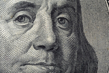 Portrait of Ben Franklin on the US 100 dollar bill in macro. Benjamin Franklin on hundred dollar...