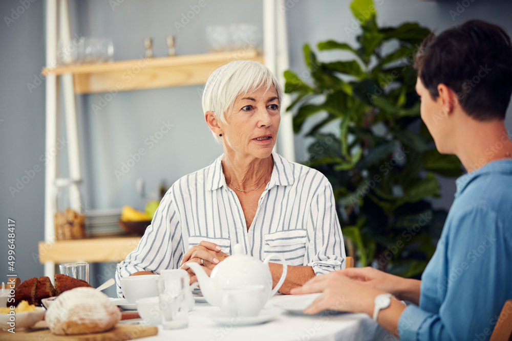 Canvas Prints Her story-telling nature never changed. Cropped shot of an affectionate senior woman having tea with her daughter on a dining table at home.