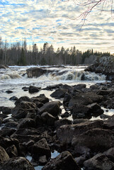 Small waterfall on a cloudy sunset