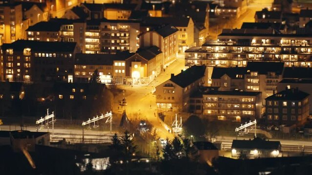 Narvik city at night. Timelapse video.Cars moving through the brightly lit streets.