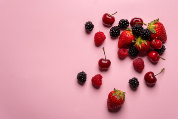 close up of red fruits over pink background