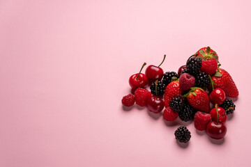 close up of red fruits over pink background