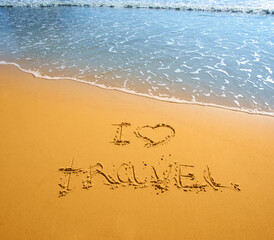 Fototapeta premium handwritten words I love travel on sand of tropical beach