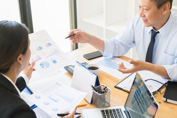 Fototapeta premium Business adviser analyzing financial figures denoting the progress Internal Revenue Service checking document. Audit concept