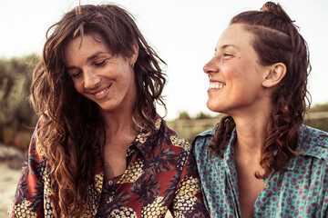 Sweet moment between pretty lesbian couple beach camping in Portugal