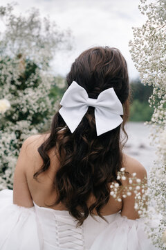 Bride in a wedding dress and with a bow