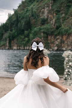 Bride in a wedding dress and with a bow