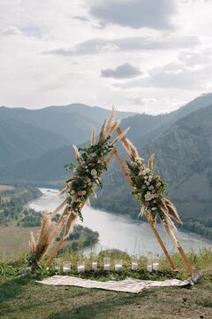 Wedding arch in the shape of a triangle with flowers