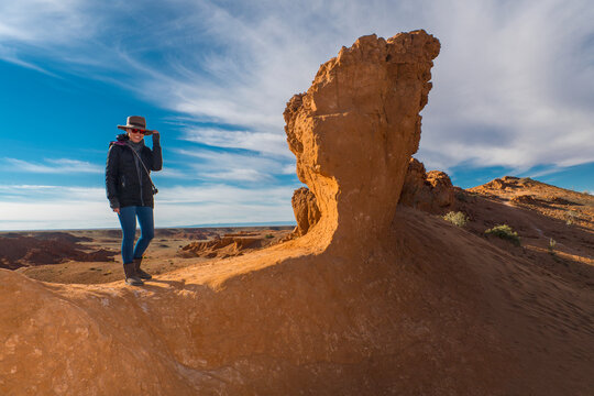 woman posing for the camera at the Flaming cliffs in the Gobi desert