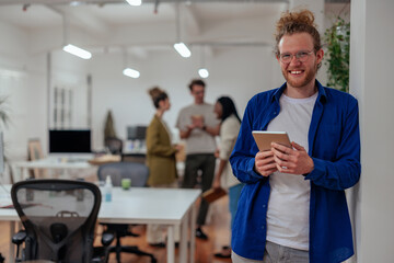 Young businessman using digital tablet in the office