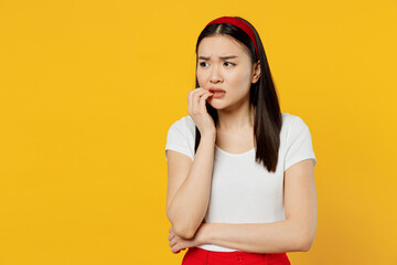 Nervous disturb young girl woman of Asian ethnicity 20s years old wears white t-shirt looking aside...