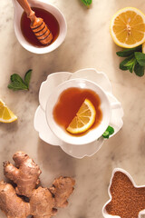 Ginger tea, with lemon, mint and honey, on a marble table, top view, sunlight, no people, selective focus,