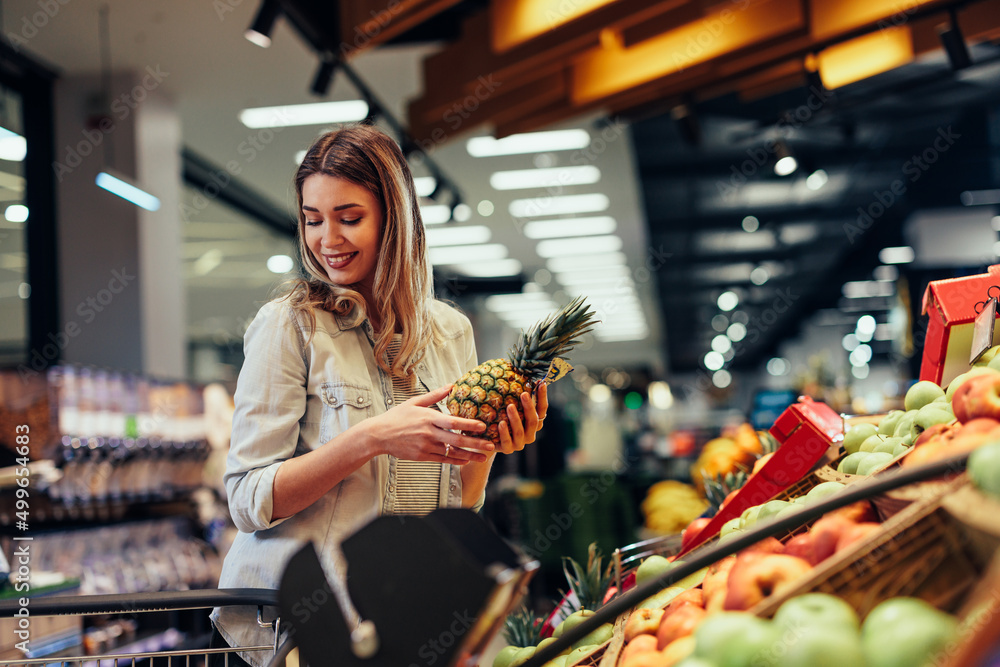 Wall mural woman buying fresh fruits and vegetables