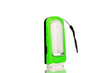 One battery operated flashlight, close-up, isolated on a white background.