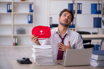 Young male employee feeling bad at workplace