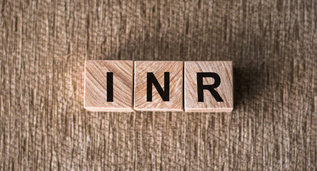 INR - International Normalized Ratio acronym on cubes on wooden surface. Medical concept.