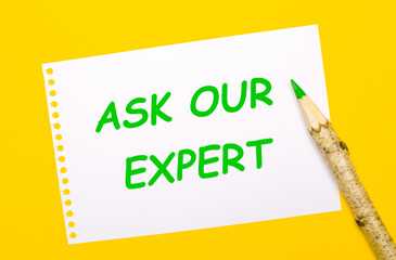 On a bright yellow background, a large wooden pencil and a white sheet of paper with the text ASK OUR EXPERT