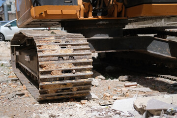 Excavator caterpillars at construction site close-up
