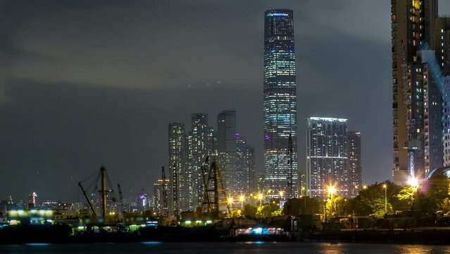 Hong Kong business center day to night timelapse with a cloudy blue sky after sunset