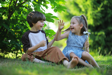 Children walk in the summer in nature. Child on a sunny spring morning in the park. Traveling with children.