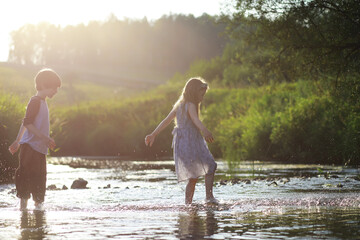 Children walk in the summer in nature. Child on a sunny spring morning in the park. Traveling with children.