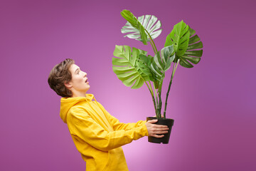 boy with room plant