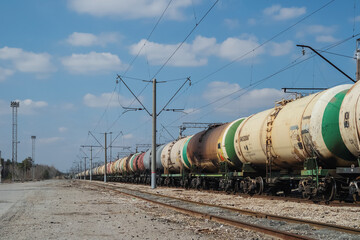 Fototapeta na wymiar Freight trains with old grubby tanks at the station.