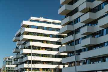 Modern residential buildings with green gardens on balconies